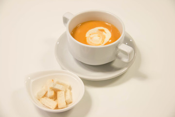 Pumpkin  soup with cream in  white cup