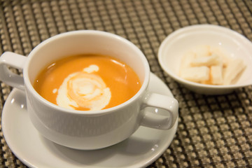  Pumpkin  soup with cream in  white cup