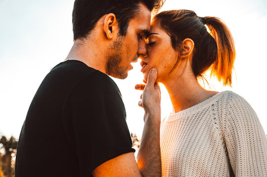Couple in love kiss outdoor at sunset