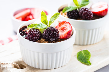 Crumble pie with berry mix, granola and ice cream.