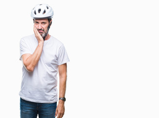 Middle age senior hoary cyclist man wearing bike safety helment isolated background thinking looking tired and bored with depression problems with crossed arms.