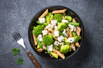 Whole-grain pasta penne with broccoli, avocado, green beans, pea