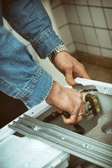 Technician Fixing Washing Machine