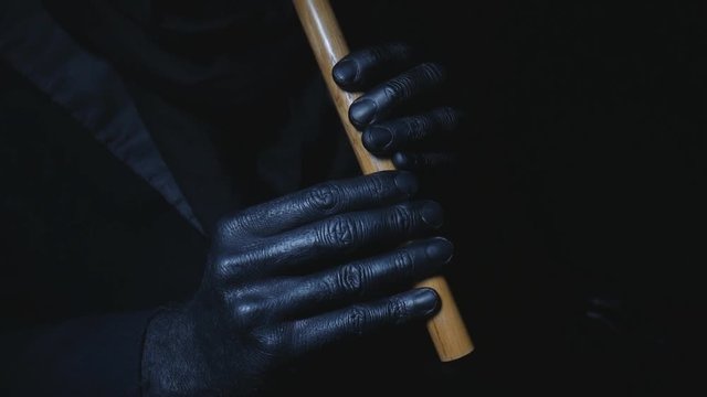 Black hands Playing the flute