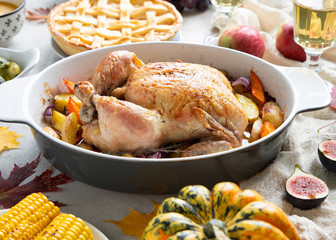 Thanksgiving dinner with chicken, apple pie, pumpkin soup brussel sprouts and fruits.