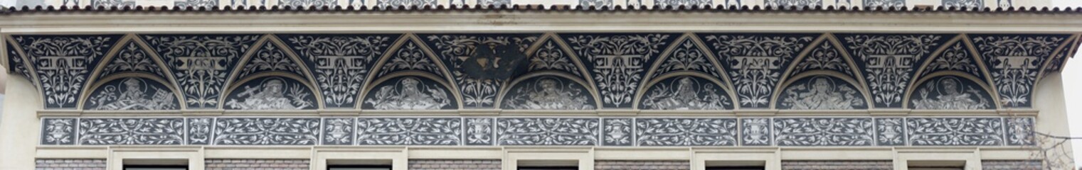 Close-up of lunette cornice with 19th century graffito on building in national property of  vicarage St. Peter on Biskupska (Bishop) Street, 1137 in Prague, Czeck Republic.
