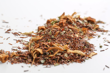 Still life, aromatic dry tea with fruits and petals, close up on white background