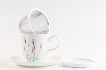 close up of empty cup of tea on white
