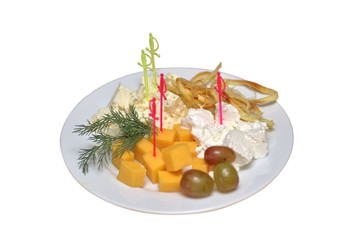 Various cheeses with greens and grapes on white plates, isolated closeup