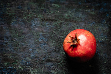 pomegranate fruit on a dark background, top view