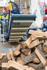 Machine for cutting firewood. chopping firewood with a machine close up. vertical photo