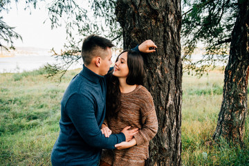 photo shoot of a beautiful brunette and her boyfriend in nature