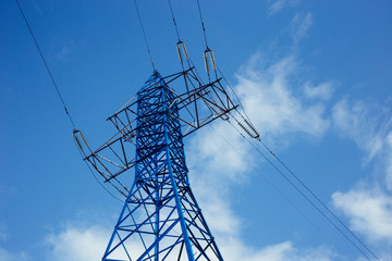 bottom view of the tower of power grids on blue sky background, High voltage, Electricity concept