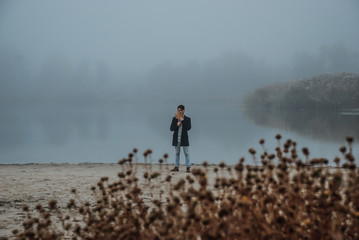 The lonely man walking outsides, where full of mist in morning