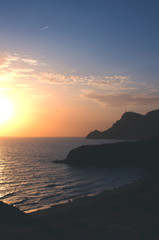 Mediterranean coastline, lonely beach and mountains in Cabo de Gata at sunset. Cala Barronal, Almeria, Andalucia, Spain