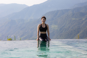 Vacations of Woman relax in tropical infinity pool above the Mountain peak in the morning in front of beautiful nature views in SAPA vietnam,Feel so Happiness and comfortable in holidays