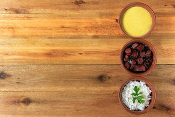 Brazilian feijoada, traditional dish of the Brazilian cuisine, on wooden table