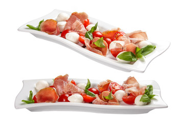 Caprese with prosciutto on a white plate