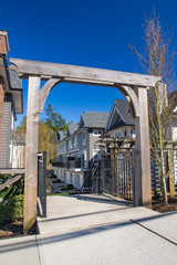 Suburban residential street townhomes. On bright sunny spring day against bright blue sky.