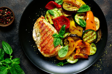Grilled chiken fillet with vegetables.Top view.