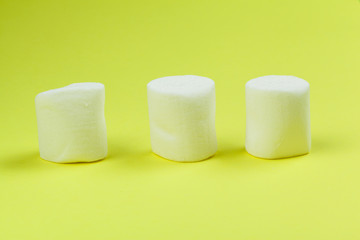 sweet marshmallow, candy on green background, top view