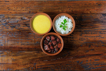 Obraz na płótnie Canvas Brazilian feijoada, traditional dish of the Brazilian cuisine, on wooden table