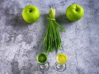 Detox juice with wheat grass and apple on top view. Nutrition food concept. Healthy drinking.