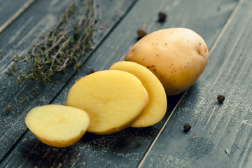 Fresh potatoes on the wood background