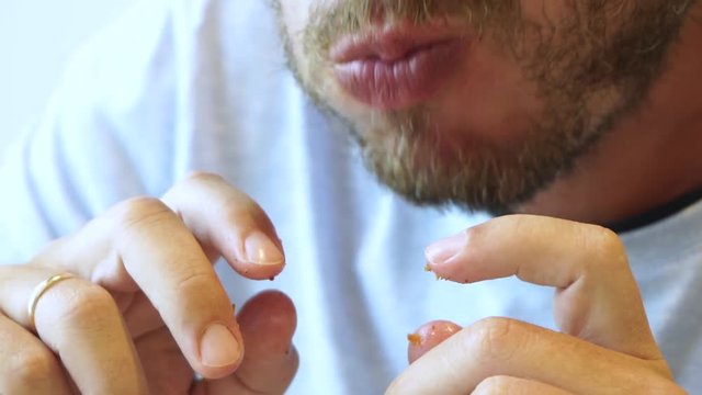 Closeup View Of Male Mouth Full Of Food And Dirty Hands With Crumbs Of Fried Chicken Wings. Person Sitting At Table At Fastfood Restaurant. Real Time Full Hd Video Footage.