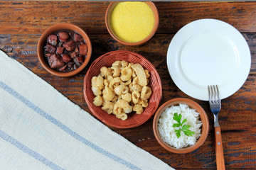 dish and fork next to feijoada, traditional brazilian culinary food top view