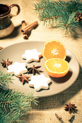 Gingerbread cookies in star shape and orange on plate