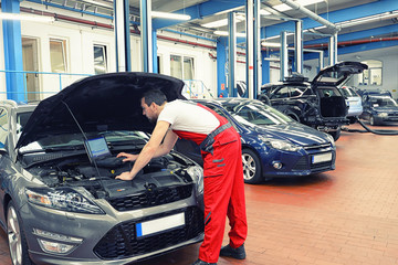 Software update and control of the electronics on the modern car in the workshop by a specialist © industrieblick