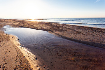 beautiful golden sunset over the sea and the beach