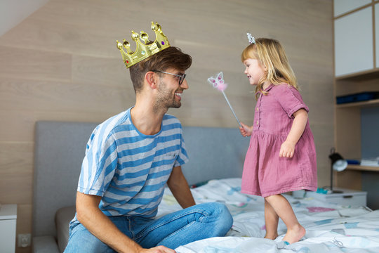 Daughter casting spell on father with magic wand
 - Powered by Adobe