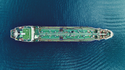 Oil Ship tanker park on the sea waiting transfer to oil refinery for transportation or energy concept background.
