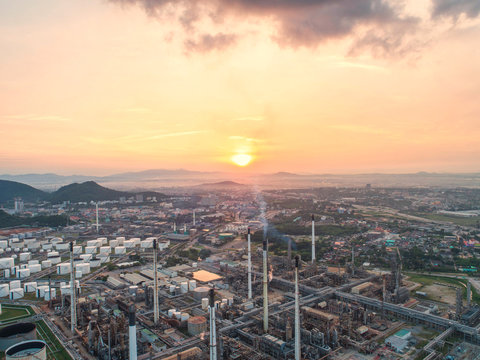 Industrial view at oil refinery plant form industry zone with sunrise and cloudy sky.Oil refinery and Petrochemical plant at dusk,Thailand. Aerial view © MAGNIFIER