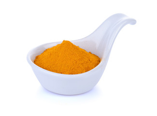 turmeric powder in bowl on white backgroun