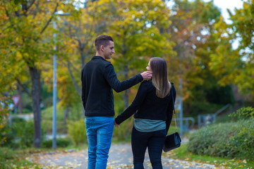 Fototapeta premium Young couple in love walking in the autumn park