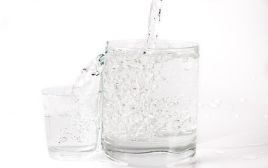 Falling and crashing glass of water. Shards of glass and splashing water