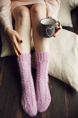 Feet girl in cozy winter socks. Winter and Christmas holidays concept.