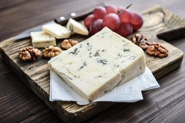 Slice of Gorgonzola cheese on cutting board