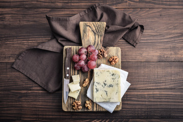 Slice of Gorgonzola cheese on cutting board