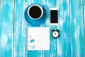 Modern workplace with cup of coffee on wooden table