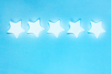 Ranking concept. 5 stars burn on blue background