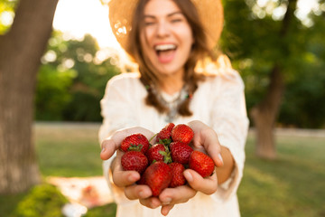 Close up of laughing young girl in summer hat