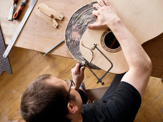 The process of making a cutaway on a classical guitar..