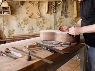 The process of making a cutaway on a classical guitar..