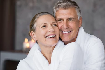 Poster Laughing senior couple embracing at spa © Rido