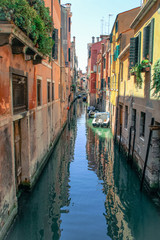 beautiful street with boats in venice italy