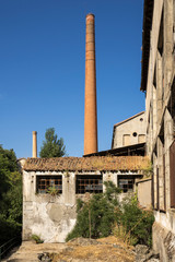 Fototapeta na wymiar Brick chimney of an abandoned factory
